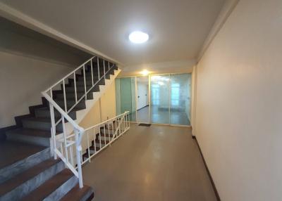 Spacious hallway with staircase and sliding glass door