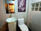Compact bathroom with modern fixtures and artwork