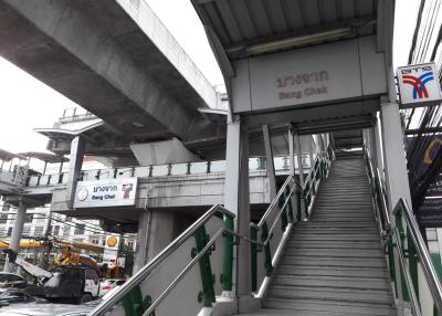 Exterior view of Bang Chak skytrain station with stairs and signage