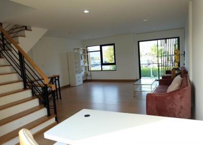 Spacious living room with natural lighting and staircase