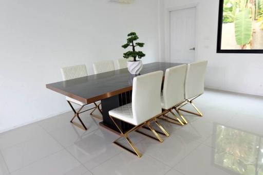 Modern spacious dining room with large table and stylish chairs