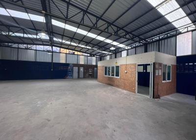 Spacious industrial warehouse interior with office unit