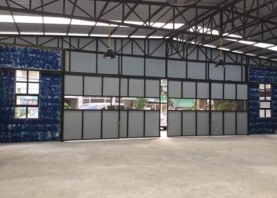Spacious commercial warehouse with large windows and high ceiling