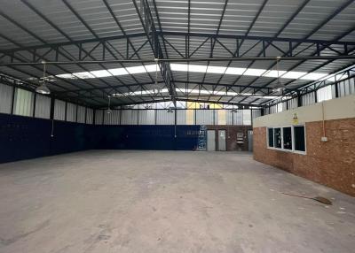 Spacious empty industrial warehouse interior with large open space