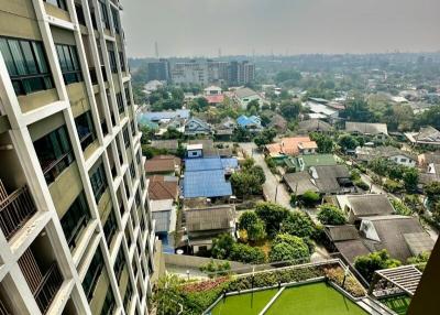 High angle view from a high-rise building overlooking a residential area with green spaces