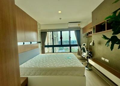 Modern bedroom with a large window and ample shelving