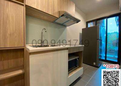 Modern kitchen with wooden cabinets and stainless steel appliances