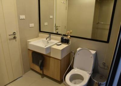 Modern bathroom interior with wooden cabinet and white fixtures