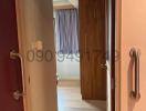 Well-lit hallway with wooden doors and laminate flooring