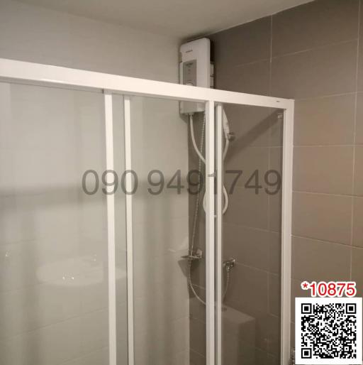 Compact bathroom with glass shower enclosure and wall-mounted water heater