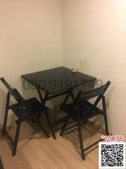 Compact dining table with chairs in a small dining area