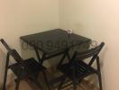 Compact dining table with chairs in a small dining area