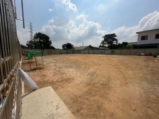 Spacious empty lot with a clear sky