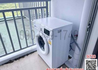 Washing machine on the balcony with railing and outdoor view