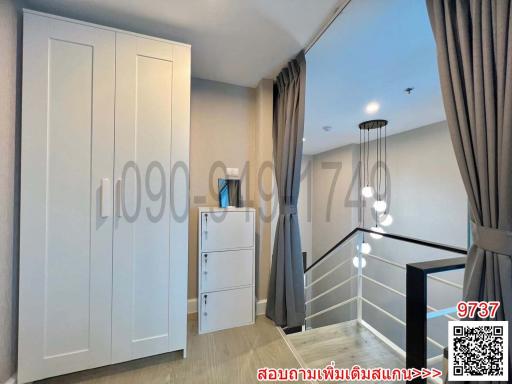 Cozy bedroom interior with modern wardrobe and staircase
