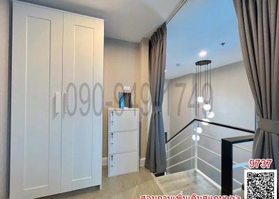 Cozy bedroom interior with modern wardrobe and staircase
