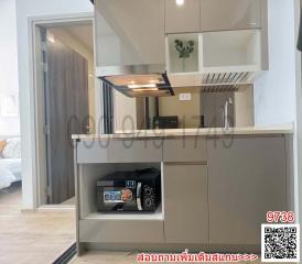 Modern kitchen with stainless steel appliances and an open view to the bedroom