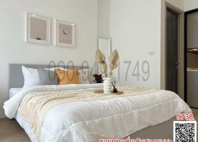 Modern bedroom with neatly made bed and wall art