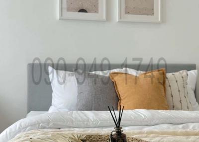 Cozy bedroom with decorative pillows and wall art