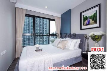 Modern bedroom with large windows overlooking the city