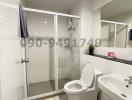 Modern bathroom interior with shower and other amenities
