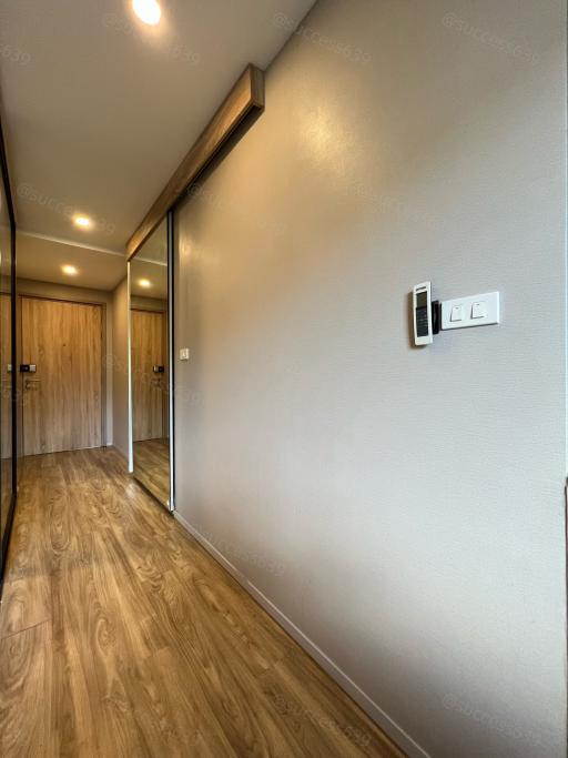 Corridor inside a modern home with wooden floors and light walls