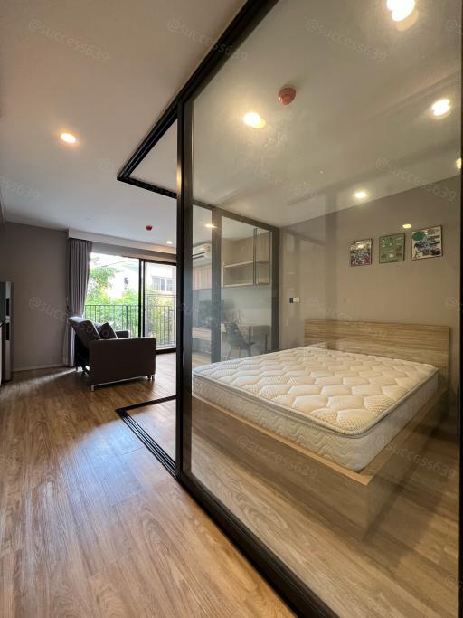 Modern bedroom with large window and wooden floor