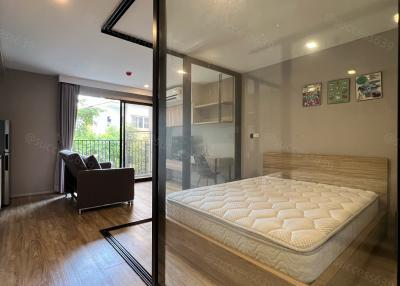 Modern bedroom with large window and wooden floor