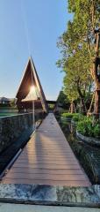 Modern Architectural Structure with Wooden Pathway and Water Feature