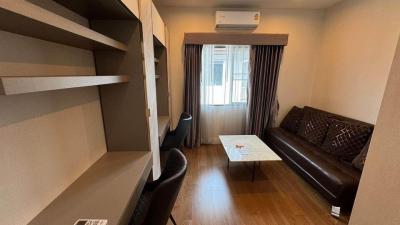 Compact living room with leather sofa and shelving unit