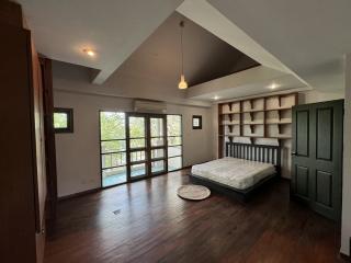 Spacious bedroom with hardwood floors and ample natural light