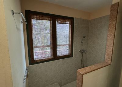 Modern tiled bathroom with glass block window and shower area
