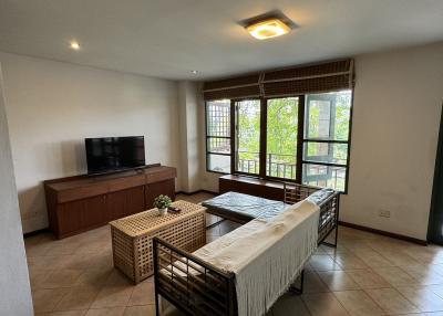 Spacious living room with natural light and balcony access