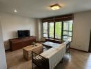 Spacious living room with natural light and balcony access