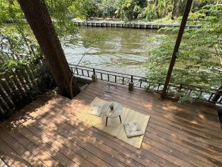 Spacious outdoor deck by the river with comfortable seating and scenic view