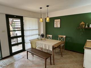 Cozy dining area with green accent wall and modern lighting