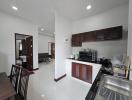 Modern kitchen with white walls and built-in wooden cabinets