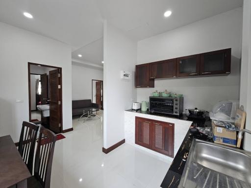 Modern kitchen with white walls and built-in wooden cabinets