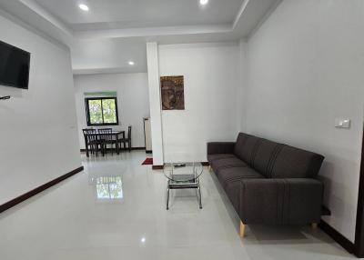 Spacious and modern living room with comfortable seating and dining area
