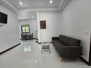 Spacious and modern living room with comfortable seating and dining area