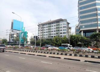 Urban road with commercial buildings and traffic