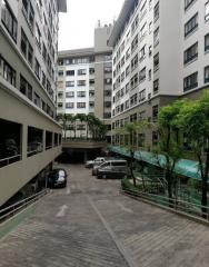 Exterior view of an apartment complex with parking area