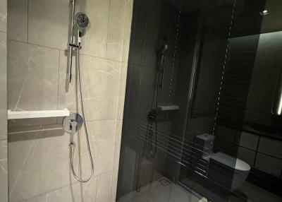 Modern bathroom with walk-in shower and glass partition