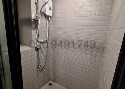 Modern bathroom interior with a walk-in shower and tiling