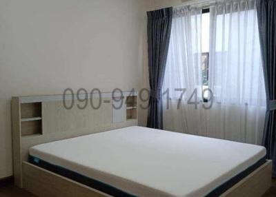 Modern bedroom with large bed and air conditioning unit