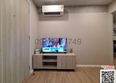 Modern living room interior with mounted television and air conditioning unit