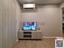 Modern living room interior with mounted television and air conditioning unit