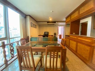 Spacious living room with dining area and city view