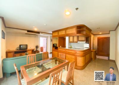 Spacious living area with dining table, couch, and open kitchen