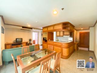 Spacious living area with dining table, couch, and open kitchen